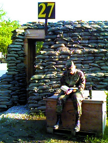 Soldier Reading Outside Bunker 2001